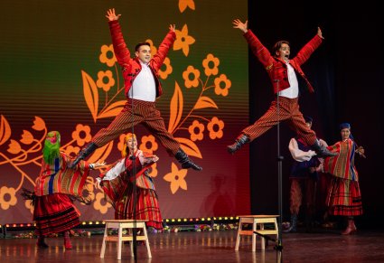 Zbliżenie na tancerzy w kostiumach sieradzkich podczas wyskoków na scenie