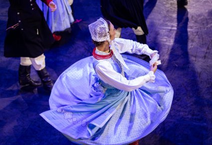 Zbliżenie na tancerkę w kostiumie szamotulskim w obrocie na scenie
