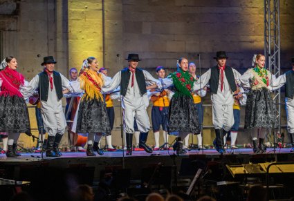 Artyści z Chorwacji w kostiumach regionalnych na scenie wykonujący choreografię
