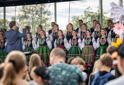 Na scenie Artyści Chóru w kostiumach łowickich wraz z Dyrygentem