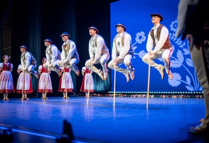 Tancerze w kostiumach jurgowskich skaczący na scenie