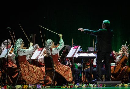 Dyrygent skierowany w stronę Muzyków z Orkiestry. Orkiestra w kostiumach wilanowskich