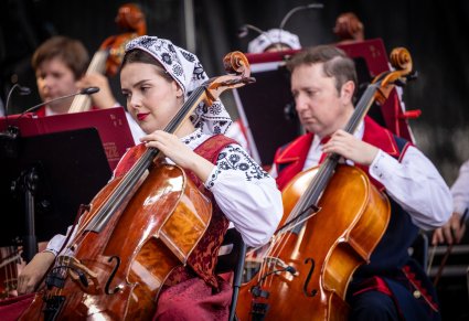 Zbliżenie na Artystów Orkiestry w kostiumach wilanowskich grających na instrumentach smyczkowych