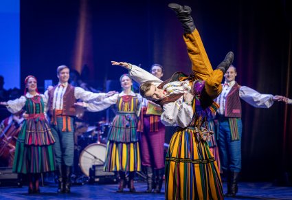 Pary Artystów w kostiumach opoczyńskich, na pierwszym planie para Artystów wykonująca spektakularne figury z choreografii tanecznej