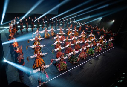 Na scenie Artyści w kostiumach ludowych podczas wykonywania finałowej choreografii