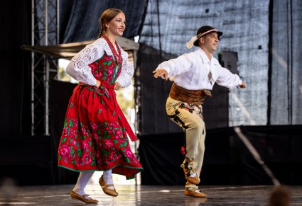 Zbliżenie na parę artystów w kostiumach podhalańskich, podczas tańców góralskich
