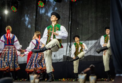 Grupa Tancerzy w kostiumach spiskich w trakcie wykonywania choreografii tanecznej
