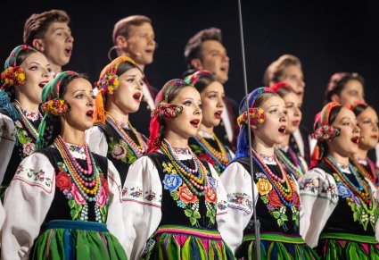 Zbliżenie na Artystów chóru w kostiumach łowickich
