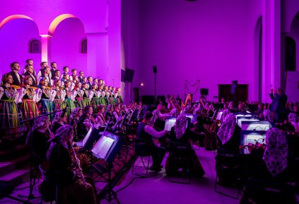 Chór, orkiestra i dyrygent podczas koncertu