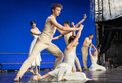 Pary Artystów w kostiumach współczesnych podczas wykonywania choreografii tanecznej