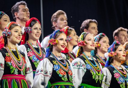Zbliżenie na artystów chóru w kostiumach łowickich