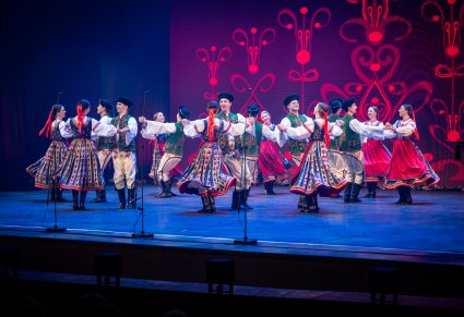 Artyści zespołu "Mazowsze" w kostiumach spiskich podczas wykonywania choreografii tanecznej na scenie