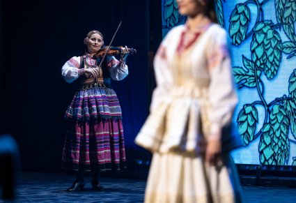 Muzyczka w kostiumie krzczonowskim grająca na instrumencie smyczkowym