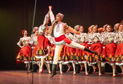Zbliżenie na parę taneczną baletu Mołdawii w kostiumach ludowych podczas tańca