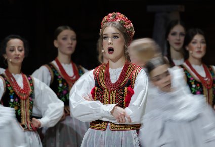 Zbliżenie na solistkę w kostiumie krakowskim podczas śpiewu