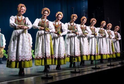 Artystki w kostiumach lubuskich, ustawione w rzędzie, w ręku trzymające kiście winogron