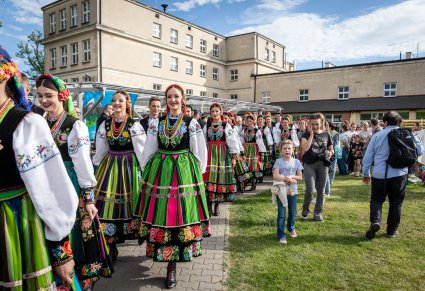Artyści Chóru w kostiumach łowickich zmierzający na scenę