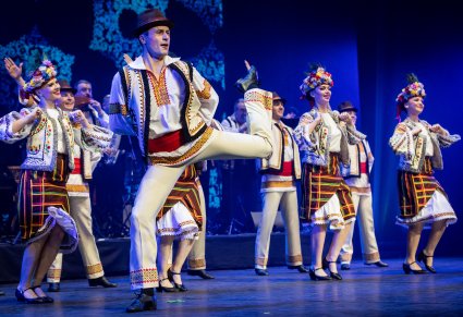 Tancerze baletu JOC w tradycyjnych kostiumach w figurach tanecznych