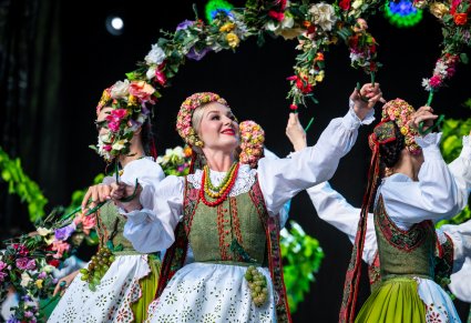 Artyści w kostiumach lubuskich na scenie wykonujący choreografię taneczną