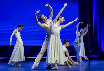 Na scenie Artyści Baletu w kostiumach współczesnych wykonujący choreografię taneczną