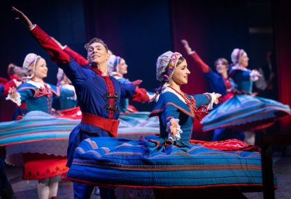Zbliżenie na pary Artystów w kostiumach kujawskich w trakcie wykonywania choreografii tanecznej
