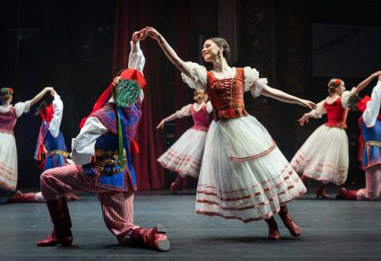 Na scenie pary Artystów w kostiumach stylizowanych na kostiumy krakowskie w trakcie wykonywania choreografii tanecznej