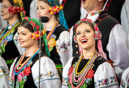 Zbliżenie na pięknie uśmiechnięte Artystki z chóru w kostiumach łowickich