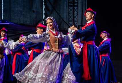 Artyści w kostiumach wilanowskich na scenie wykonujący choreografię taneczną