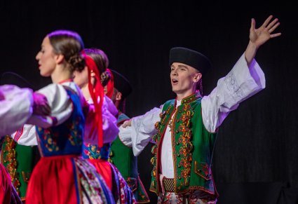 Artystka i trzy Artystki w kostiumach spiskich na scenie wykonujący choreografię taneczną